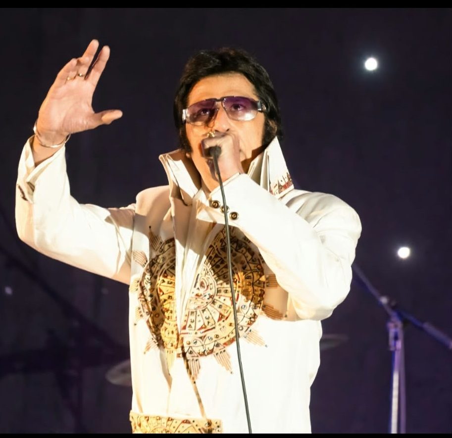 Indian Elvis on stage in the white jumpsuit